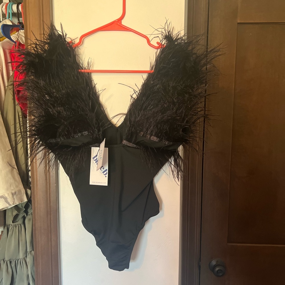 Beautiful feathered blacked body suit- never worn NWT